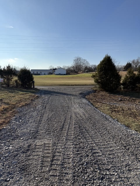 Gravel driveway leading to a Tennessee farm